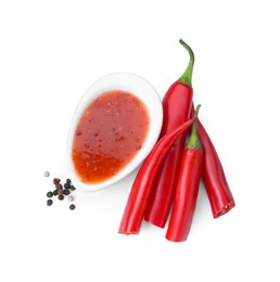 Photo of Spicy chili sauce, peppers and peppercorns isolated on white, top view