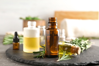 Bottles with essential oils on slate plate