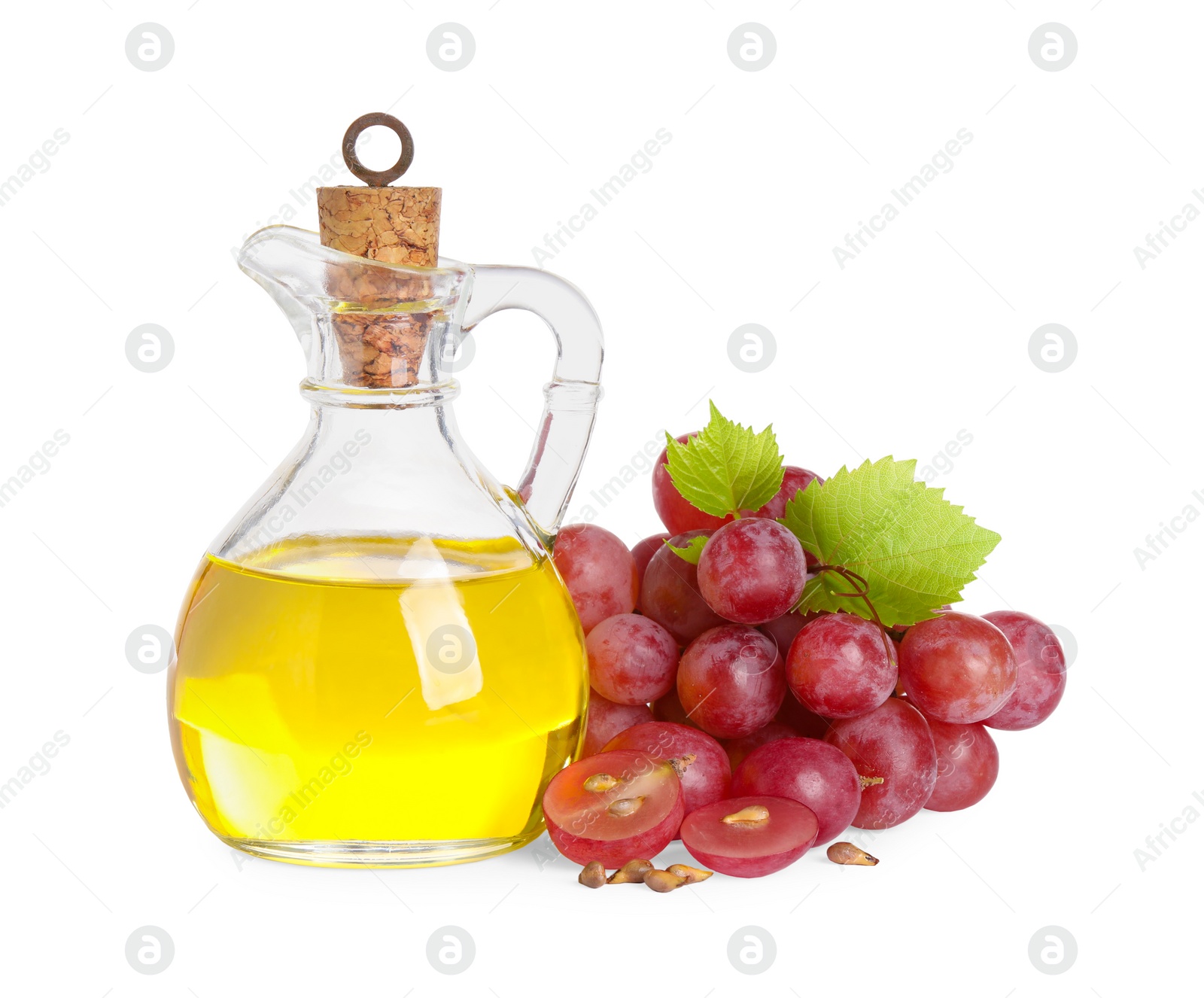 Photo of Organic red grapes, seeds and bottle of natural essential oil on white background