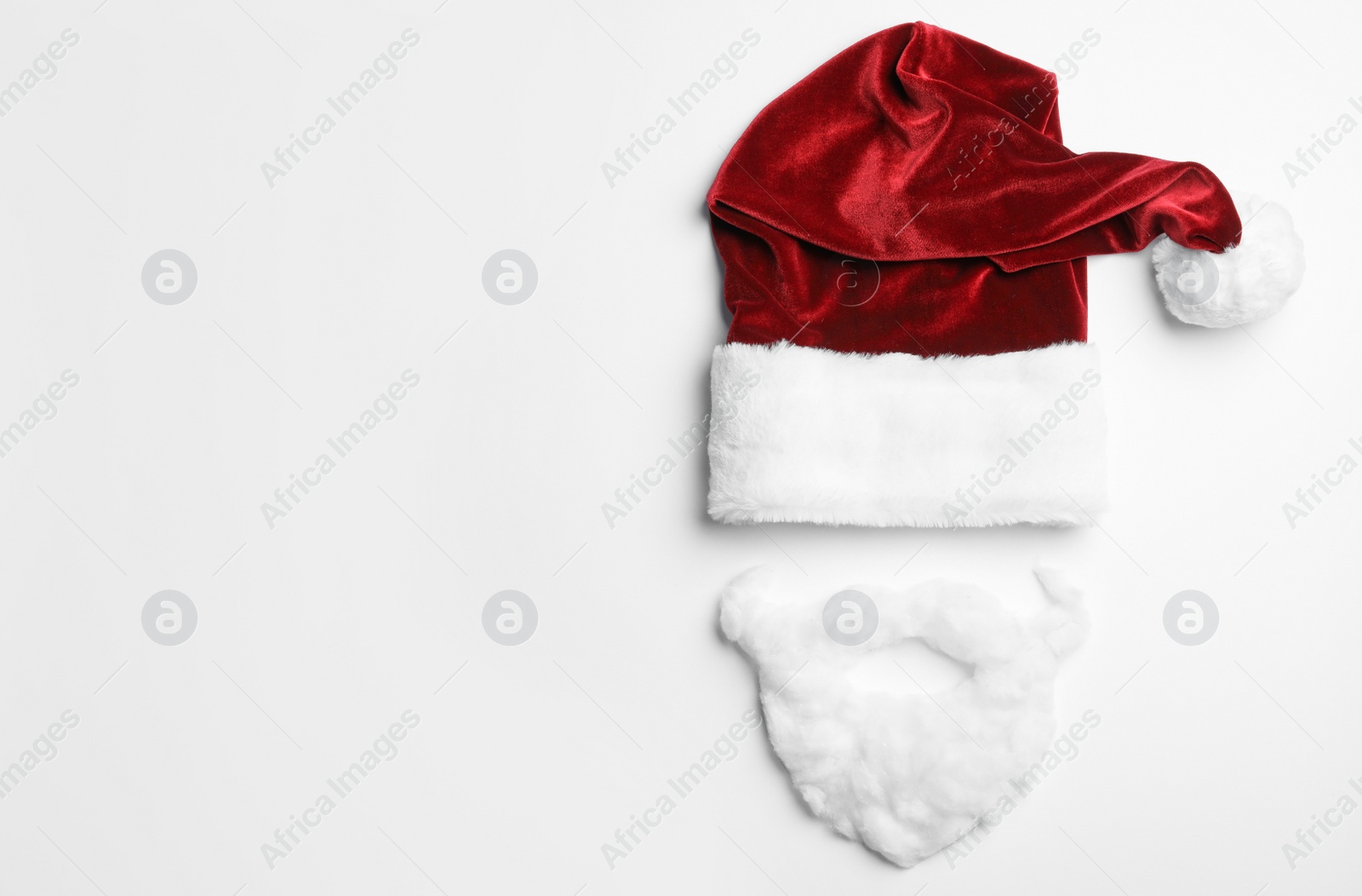 Photo of Santa Claus hat with beard on white background, top view