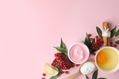 Photo of Flat lay composition with natural homemade mask, pomegranate and ingredients on pink background. Space for text