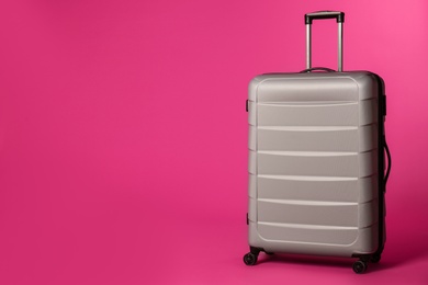 Photo of Stylish suitcase on color background. Space for text