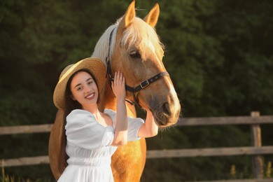 Photo of Woman with adorable horse outdoors. Lovely domesticated pet