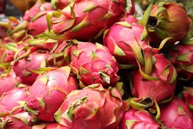 Photo of Pile of delicious fresh ripe pitahayas, closeup