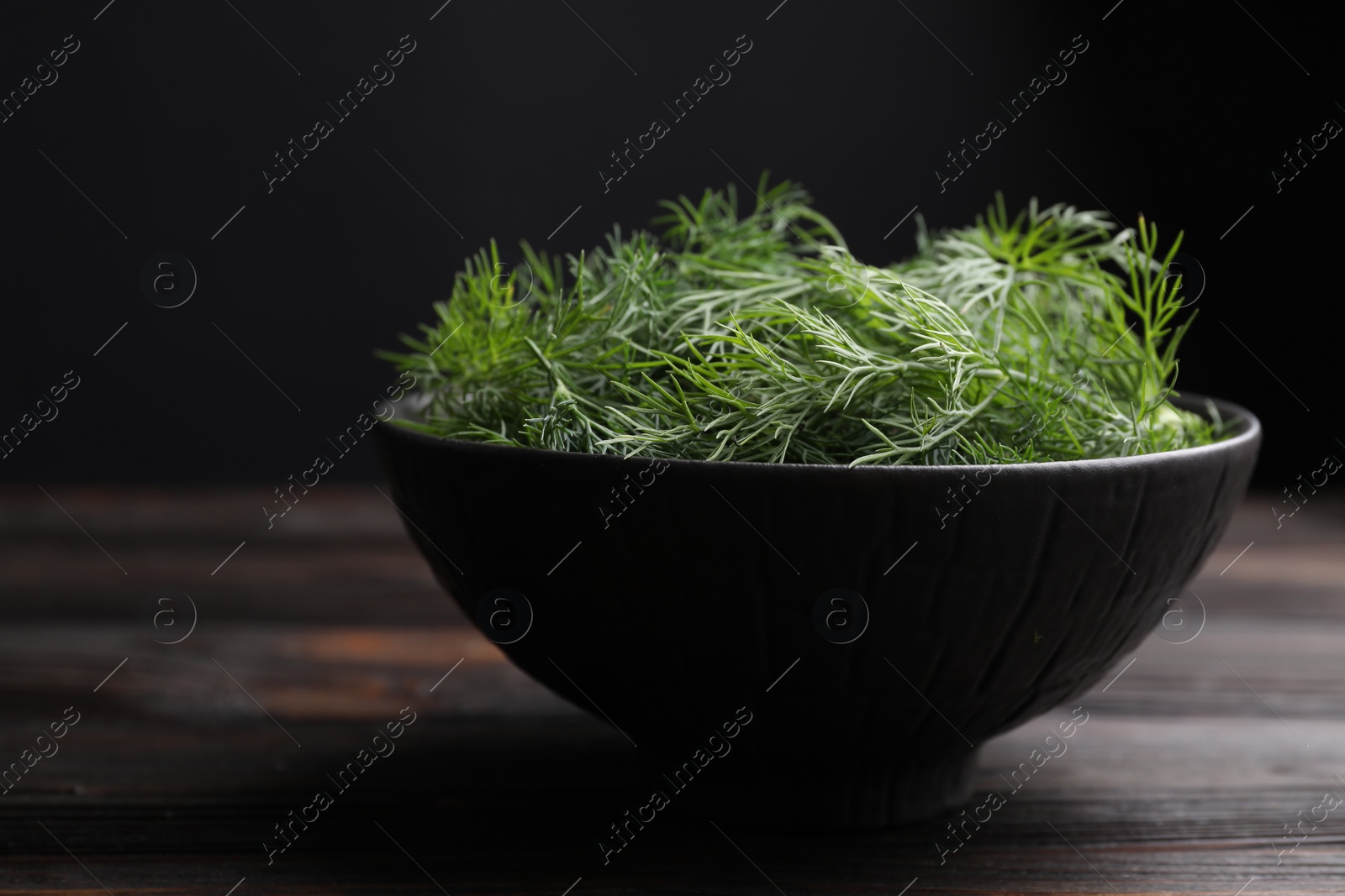 Photo of Bowl of fresh dill on table, closeup. Space for text