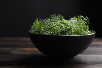 Photo of Bowl of fresh dill on table, closeup. Space for text