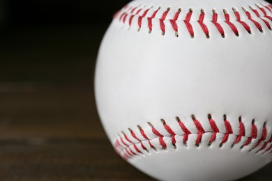 Photo of Closeup view of baseball ball on dark background, space for text. Sportive equipment