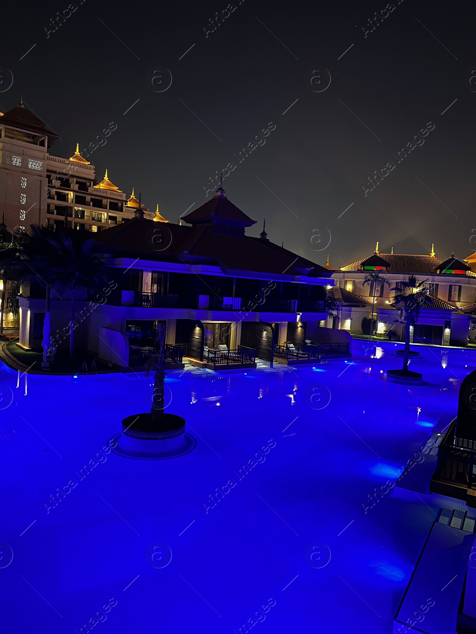 Photo of Beautiful view of swimming pool and buildings in city at night
