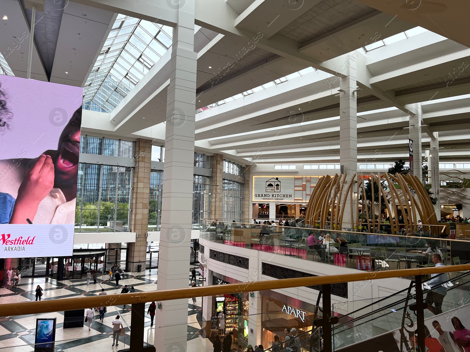 Photo of Modern shopping mall with glass ceiling, view from inside