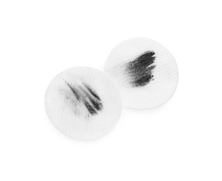 Dirty cotton pads after removing makeup on white background, flat lay
