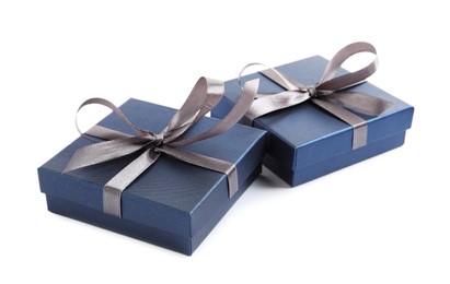 Photo of Blue gift boxes with satin bows on white background