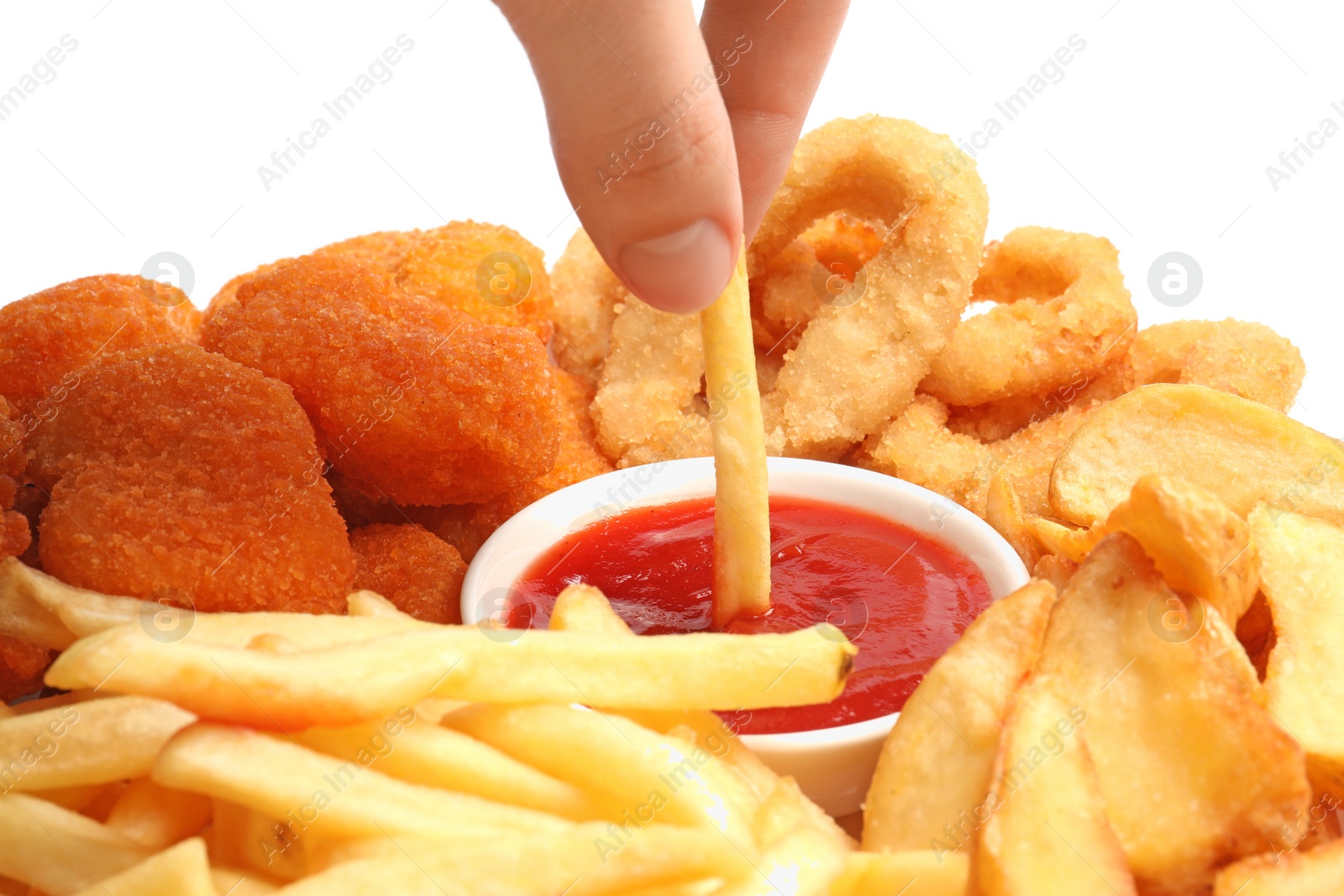 Photo of Woman dipping french fry into bowl with tasty ketchup on white background, closeup