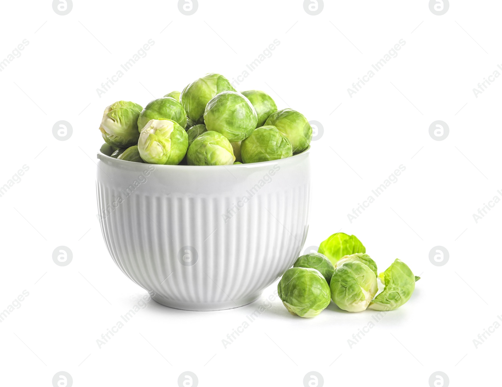 Photo of Bowl of fresh Brussels sprouts isolated on white