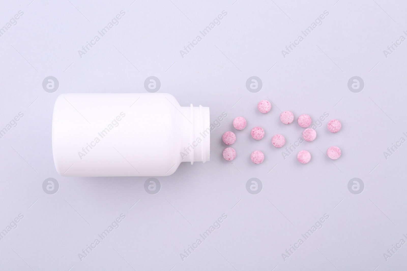 Photo of Jar with vitamin pills on white background, top view