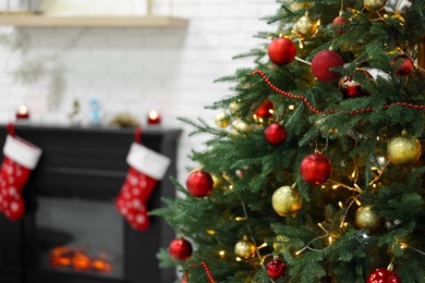 Beautiful Christmas tree near fireplace indoors. Interior design