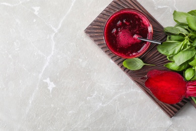 Photo of Glass of fresh beet juice, basil and vegetable on table, top view