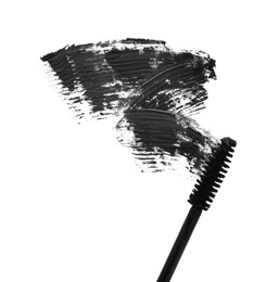 Applicator and black mascara smear on white background, top view