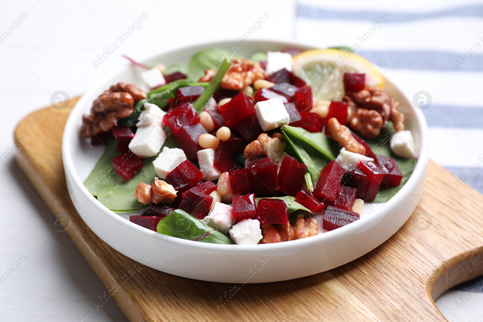 Photo of Delicious beet salad served on white table, closeup