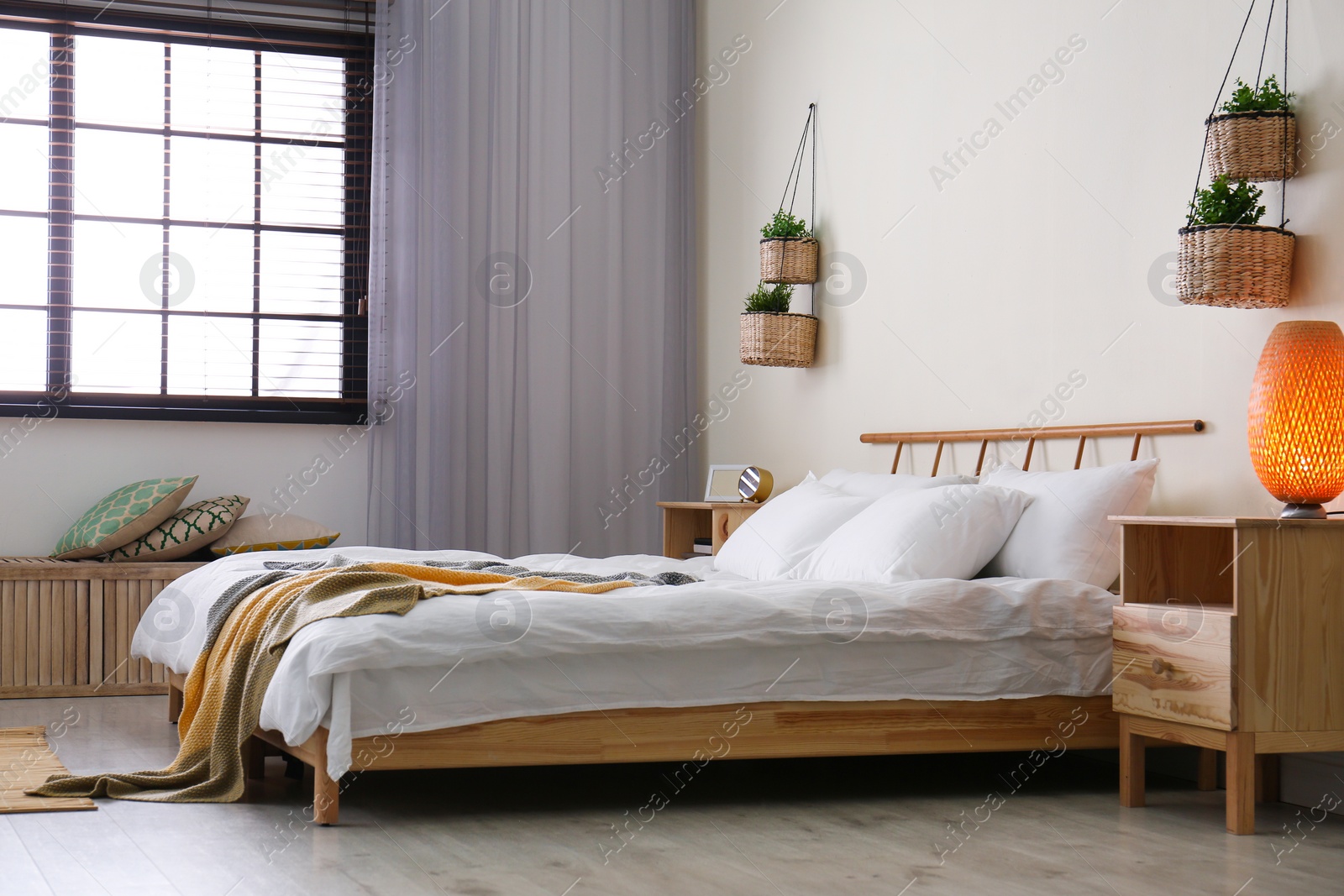 Photo of Modern room interior with comfortable double bed and window blinds