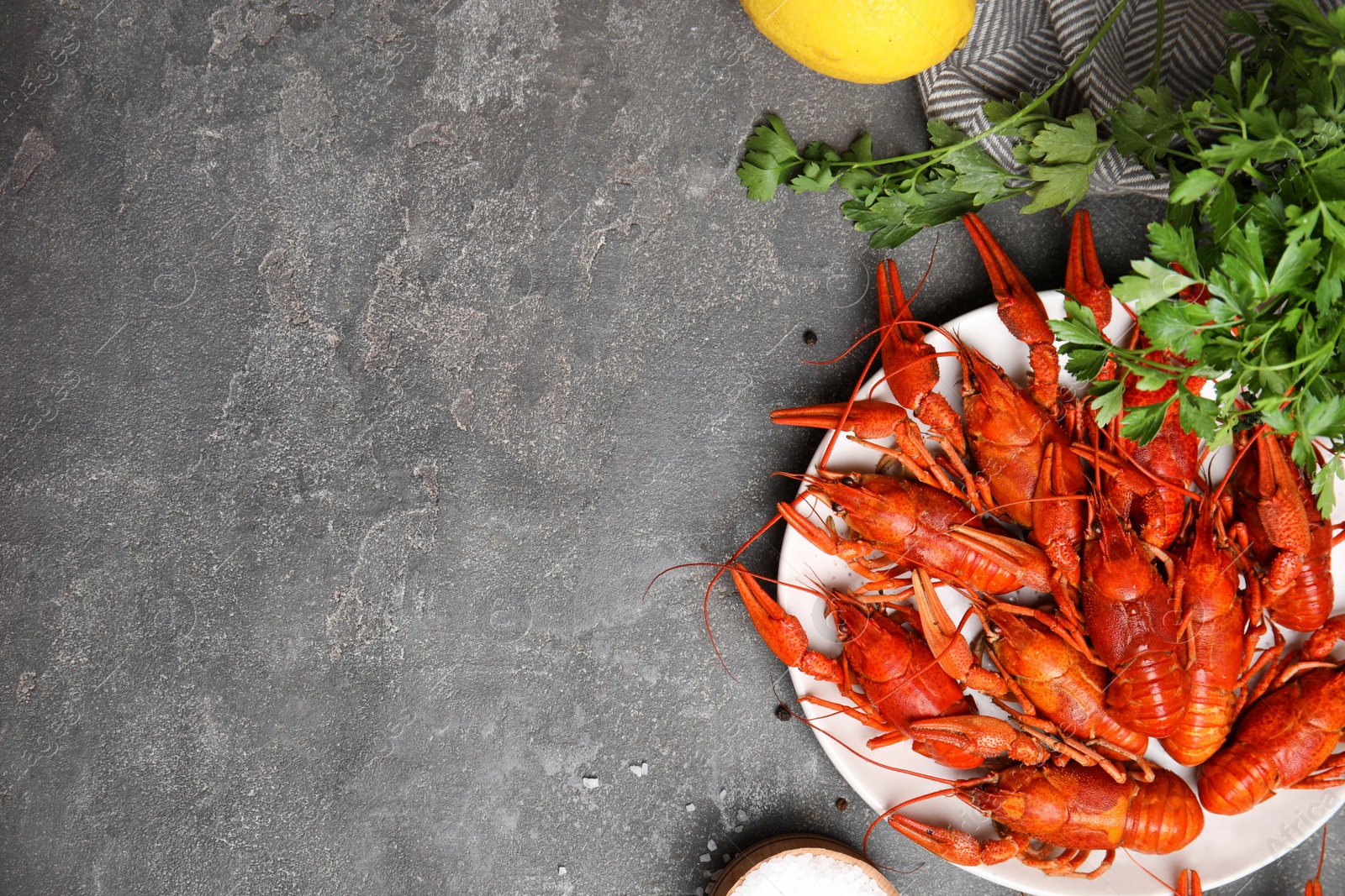 Photo of Flat lay composition with delicious boiled crayfishes on grey table, space for text