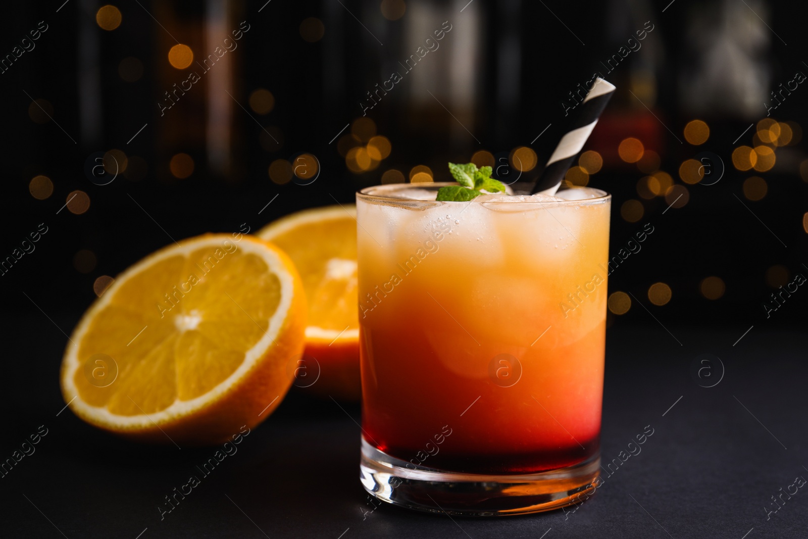 Photo of Fresh alcoholic Tequila Sunrise cocktail on grey table