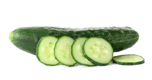 Photo of Whole and sliced fresh cucumbers on white background