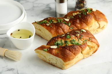 Photo of Composition with homemade garlic bread on marble table