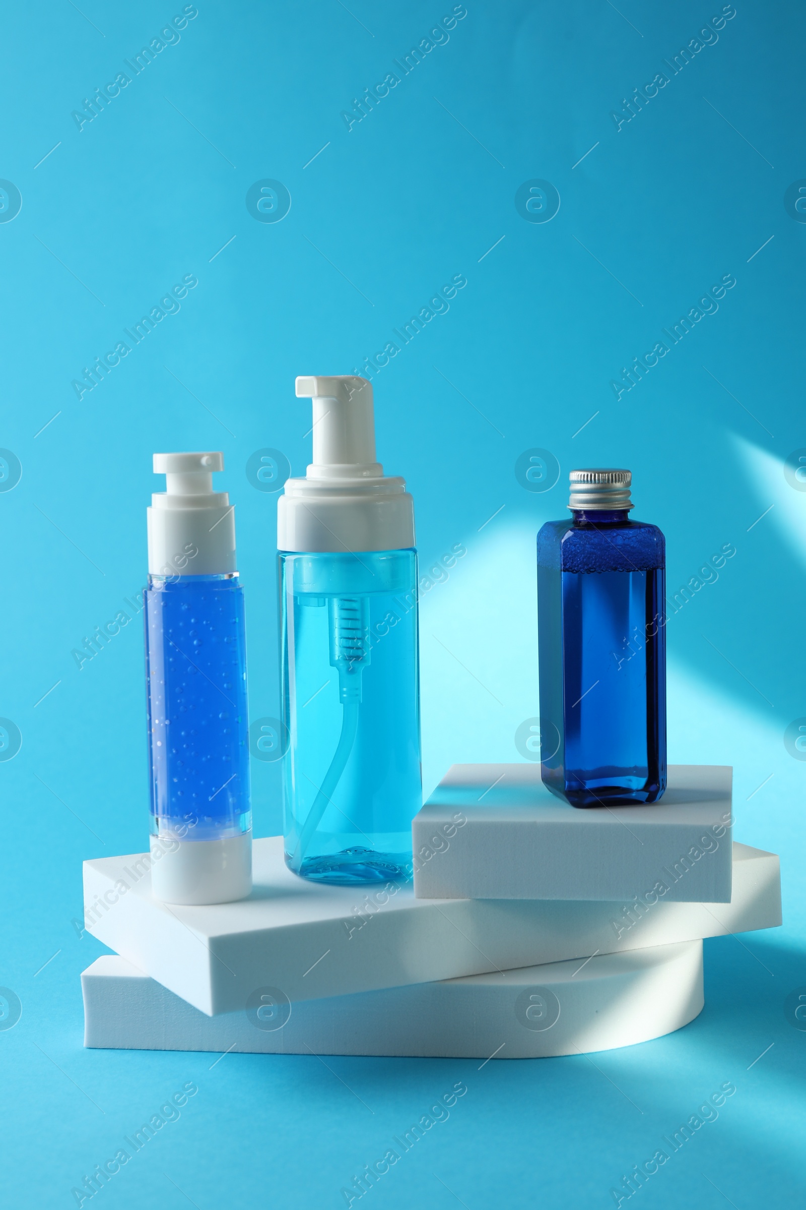 Photo of Set of luxury cosmetic products on light blue background