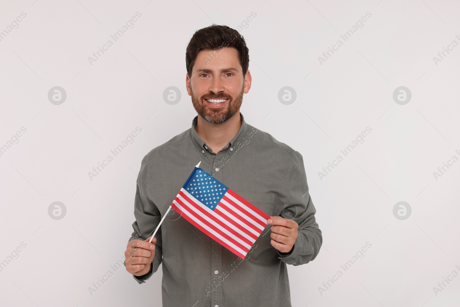 Photo of 4th of July - Independence Day of USA. Happy man with American flag on white background