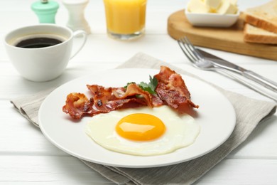 Delicious breakfast with sunny side up egg served on white wooden table