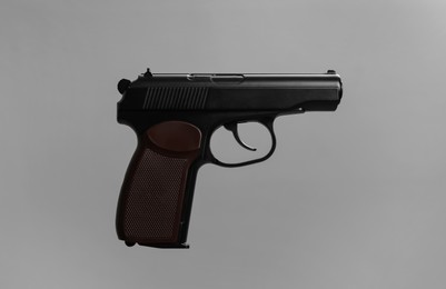 Photo of Standard handgun on grey background. Semi-automatic pistol