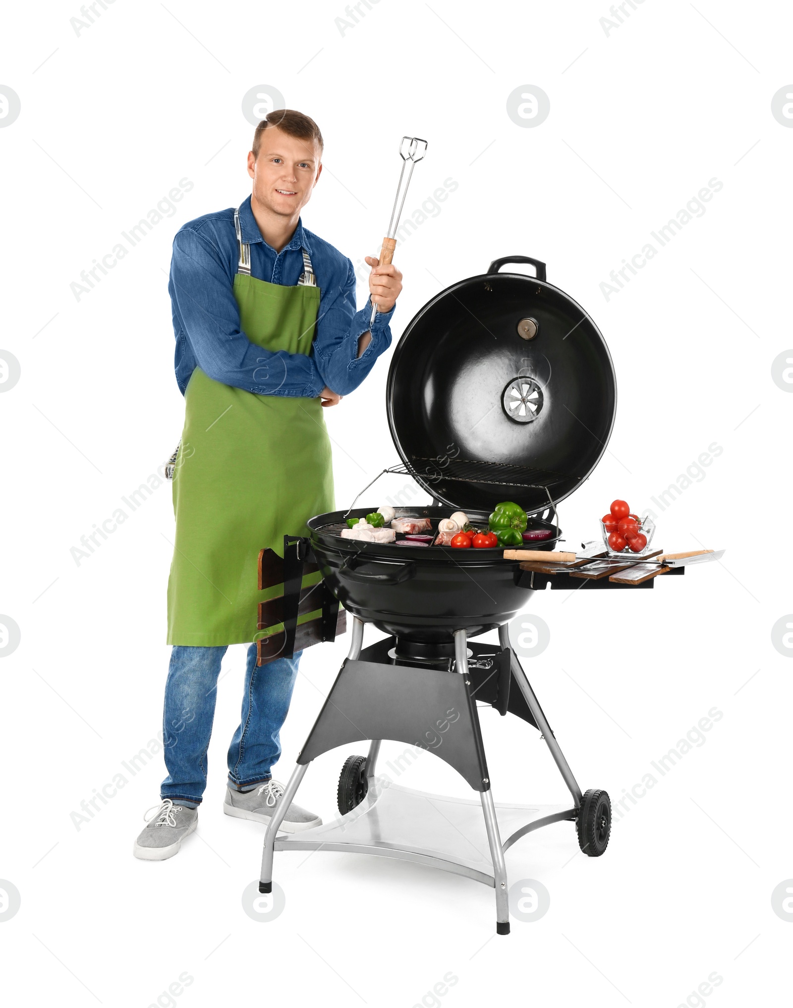Photo of Man in apron cooking on barbecue grill, white background