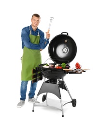 Photo of Man in apron cooking on barbecue grill, white background