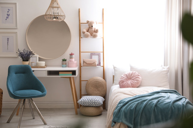 Photo of Teenage girl's bedroom interior with stylish furniture. Idea for design