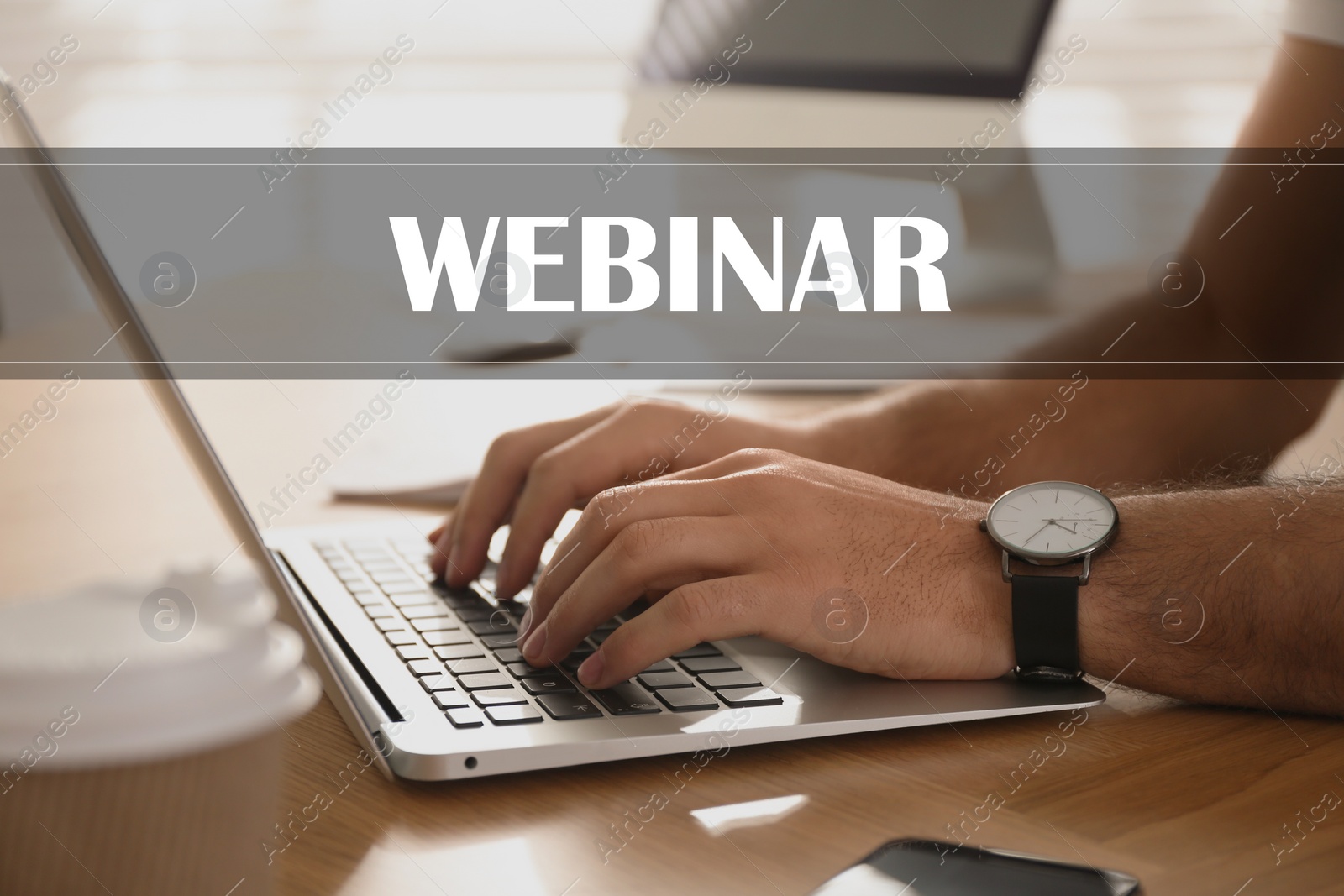 Image of Webinar concept. Man working with laptop at table indoors, closeup