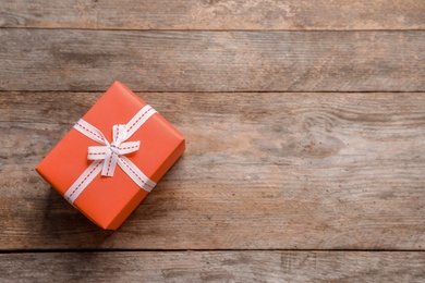 Photo of Beautiful gift box on wooden background, top view