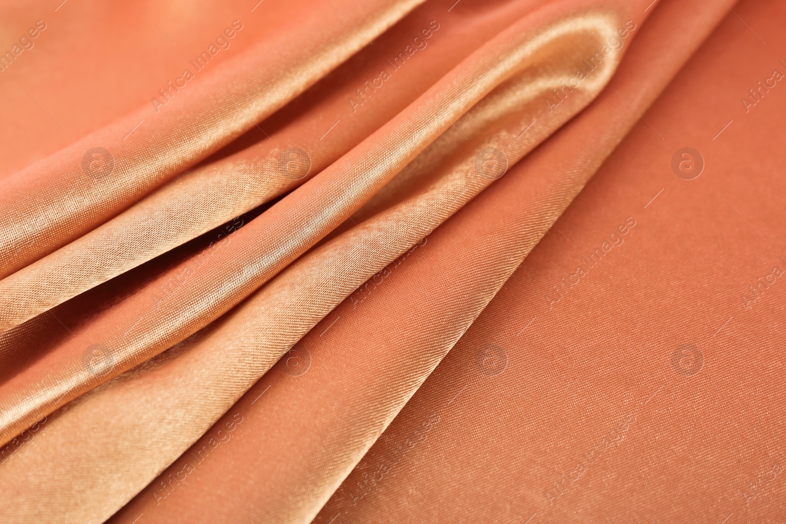 Photo of Texture of rose gold silk as background, closeup