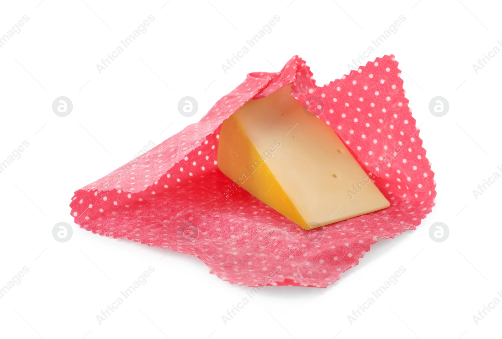 Photo of Piece of cheese in beeswax food wrap isolated on white