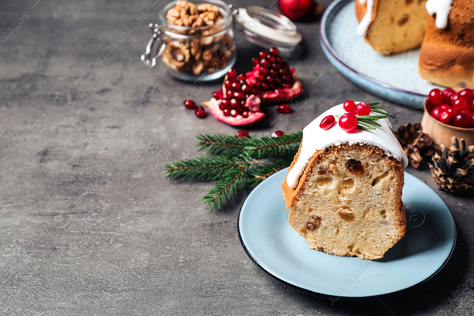 Photo of Composition with piece of traditional homemade Christmas cake on grey table, closeup. Space for text