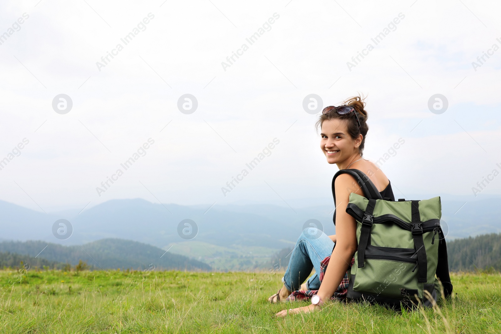 Photo of Woman with backpack in wilderness on cloudy day