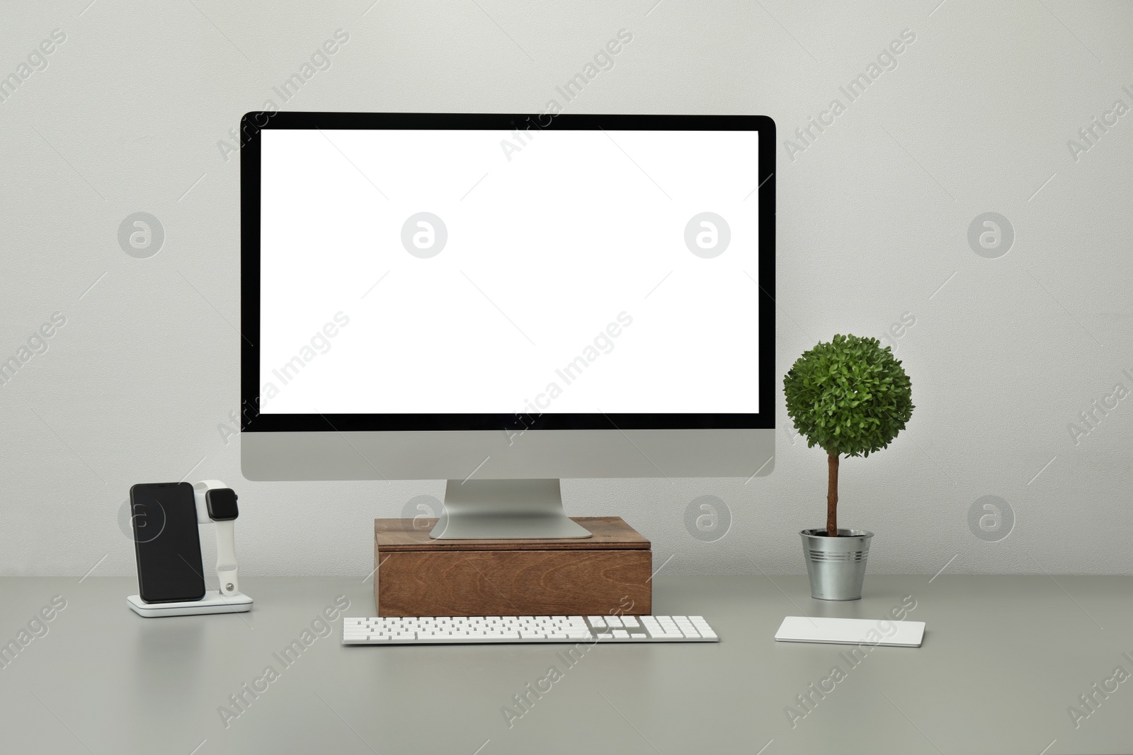 Photo of Modern workplace with computer and charging devices. Interior design