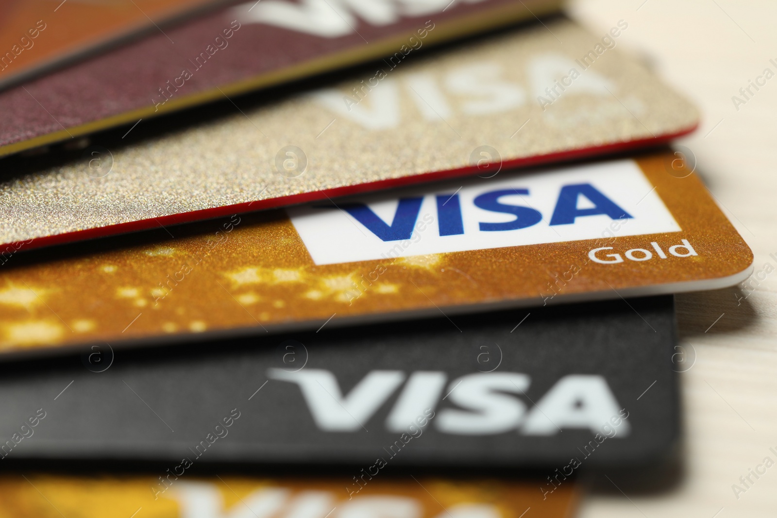 Photo of MYKOLAIV, UKRAINE - FEBRUARY 23, 2022: Bank cards of Visa payment system on table, closeup