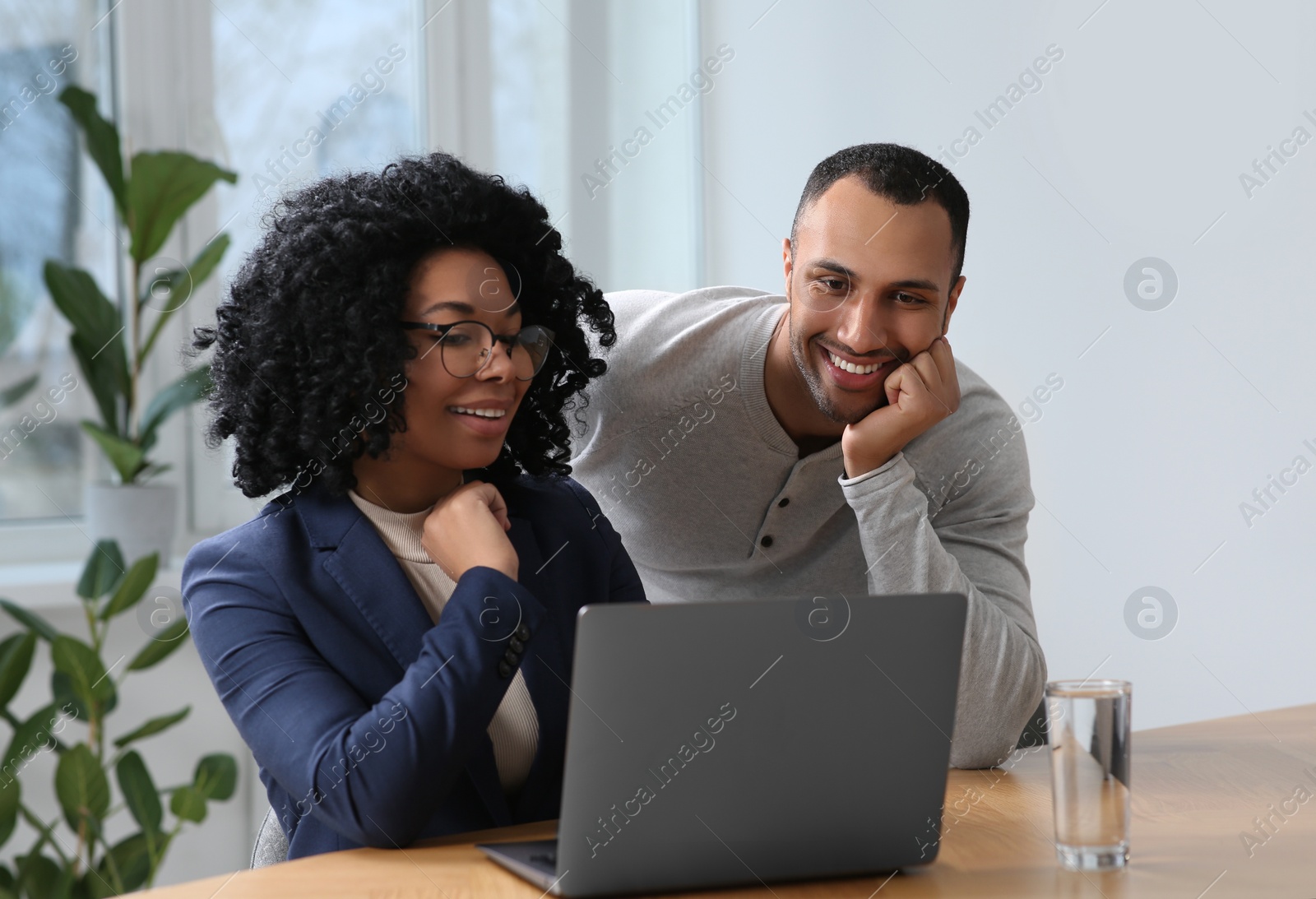 Photo of Young colleagues working together at table in office