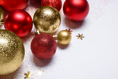 Christmas balls, confetti and glitter on white background, closeup