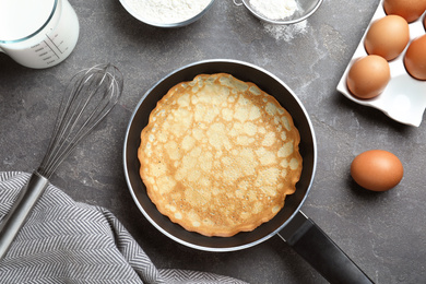 Photo of Flat lay composition with thin pancake on grey table