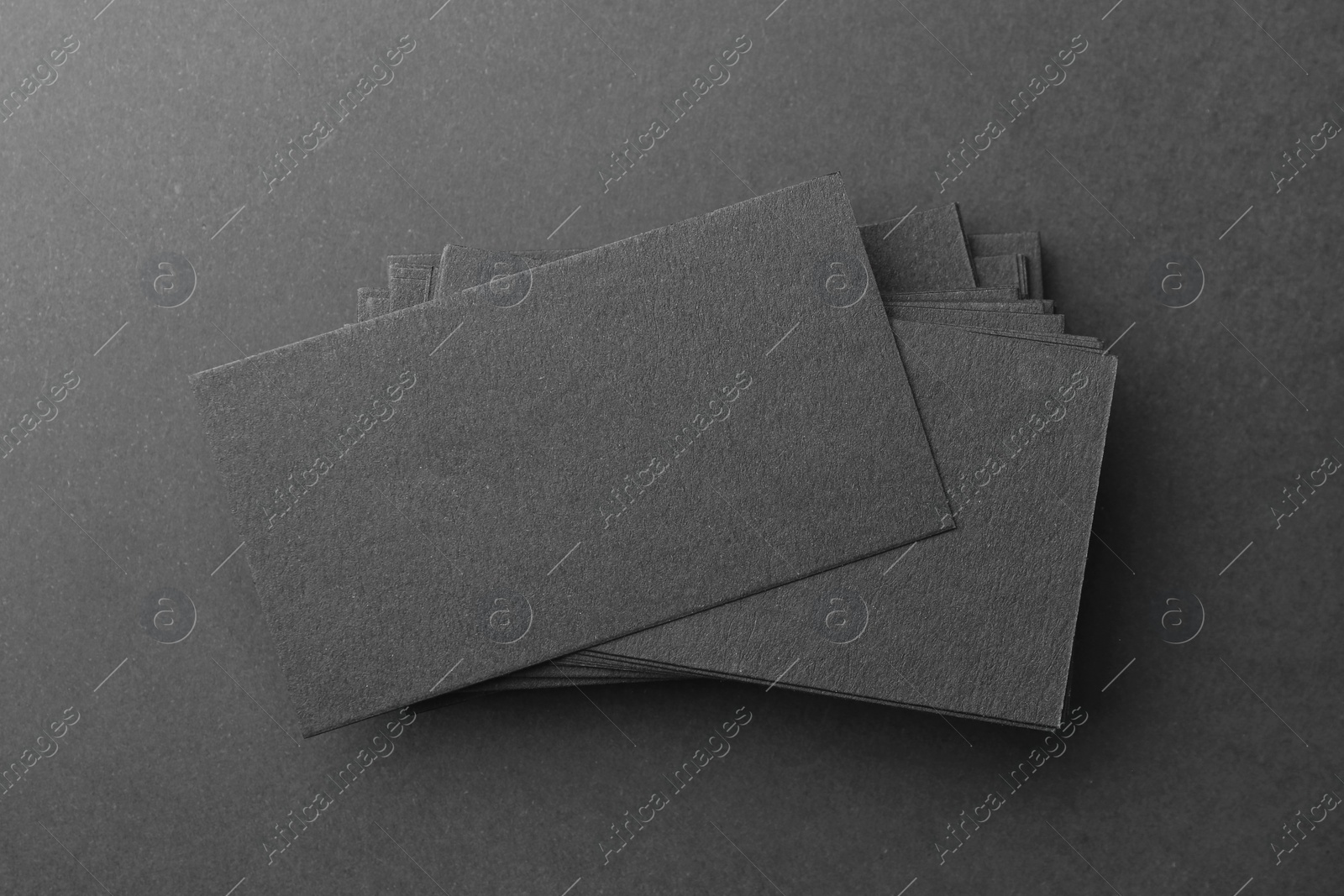 Photo of Blank business cards on black background, top view. Mockup for design