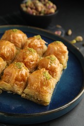 Photo of Delicious sweet baklava on black table, closeup