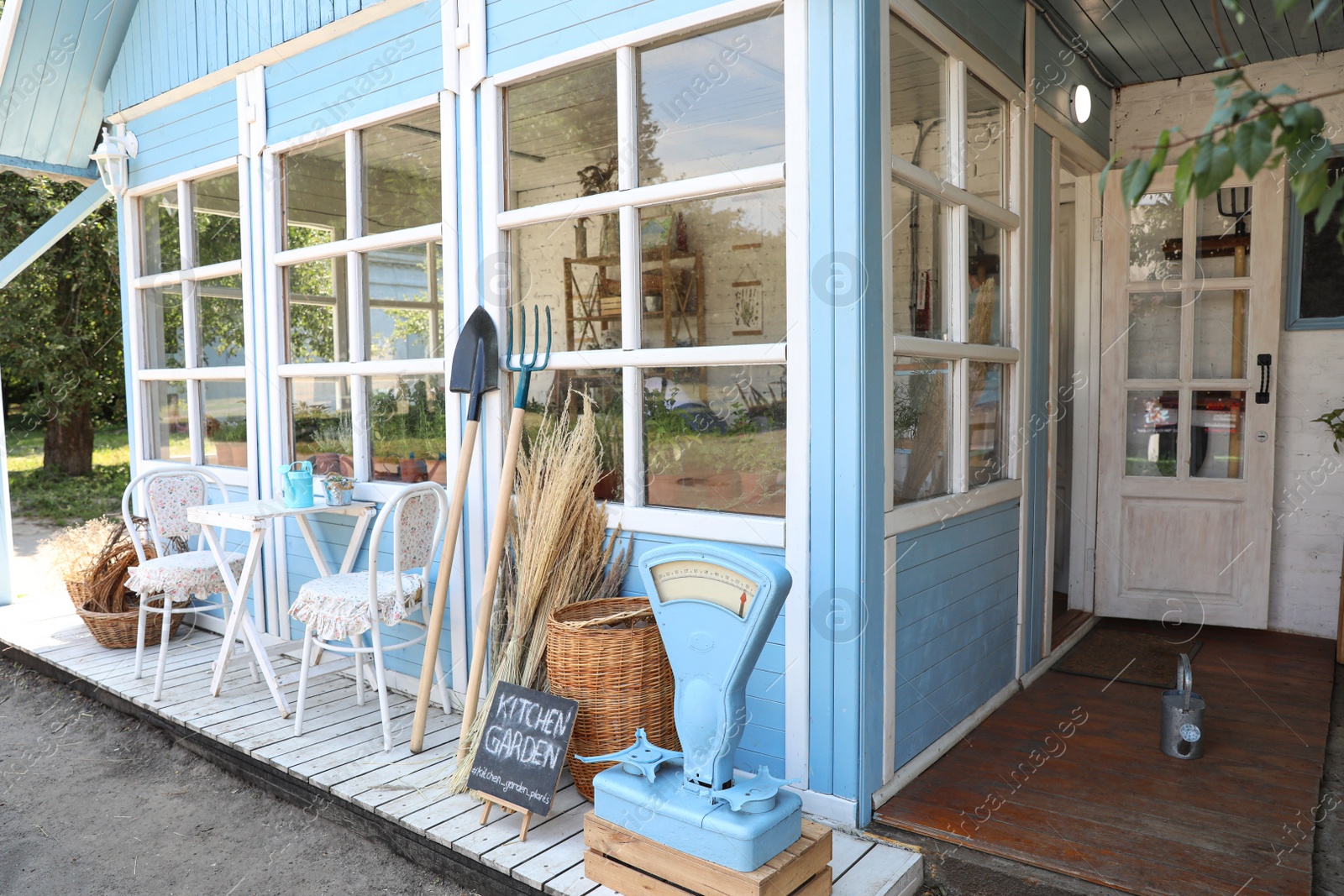 Photo of Composition with gardening tools near closed veranda outdoors