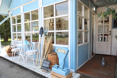 Photo of Composition with gardening tools near closed veranda outdoors