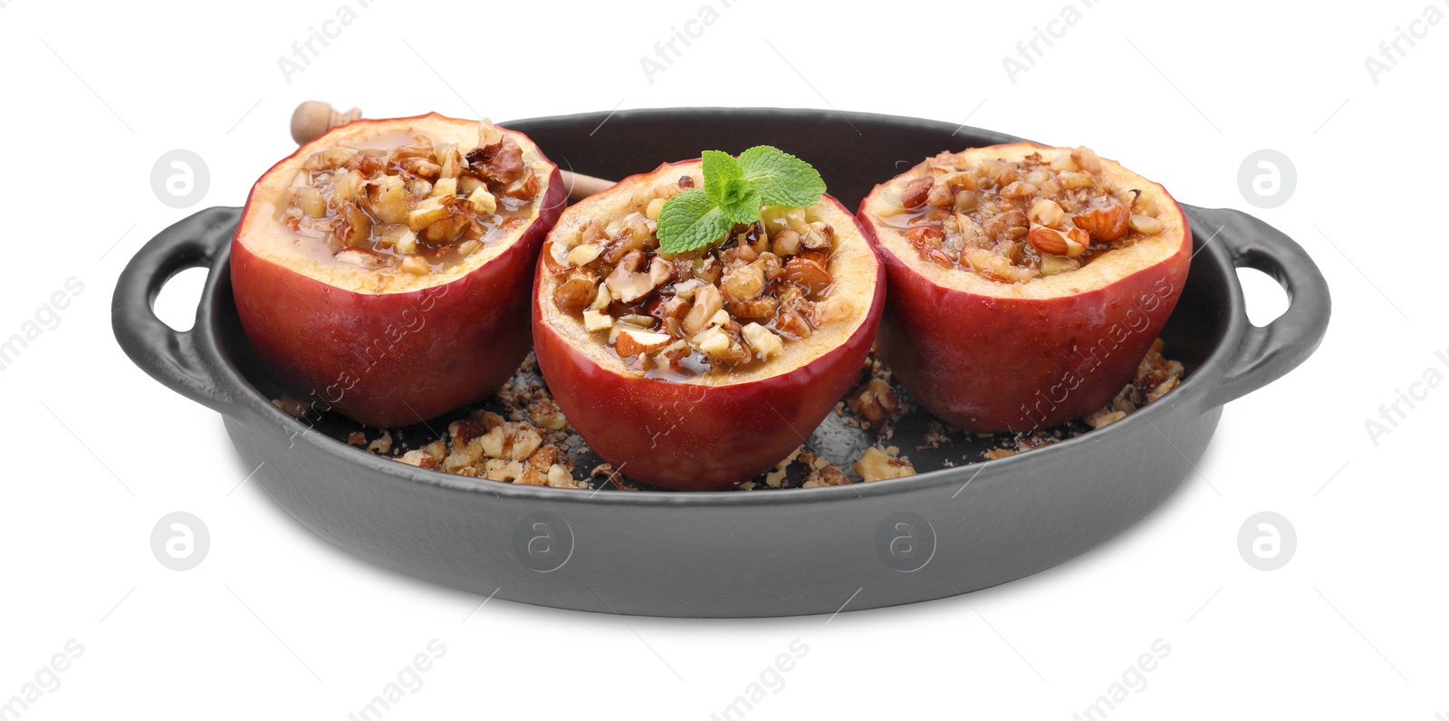 Photo of Tasty baked apples with nuts, honey and mint in baking dish isolated on white